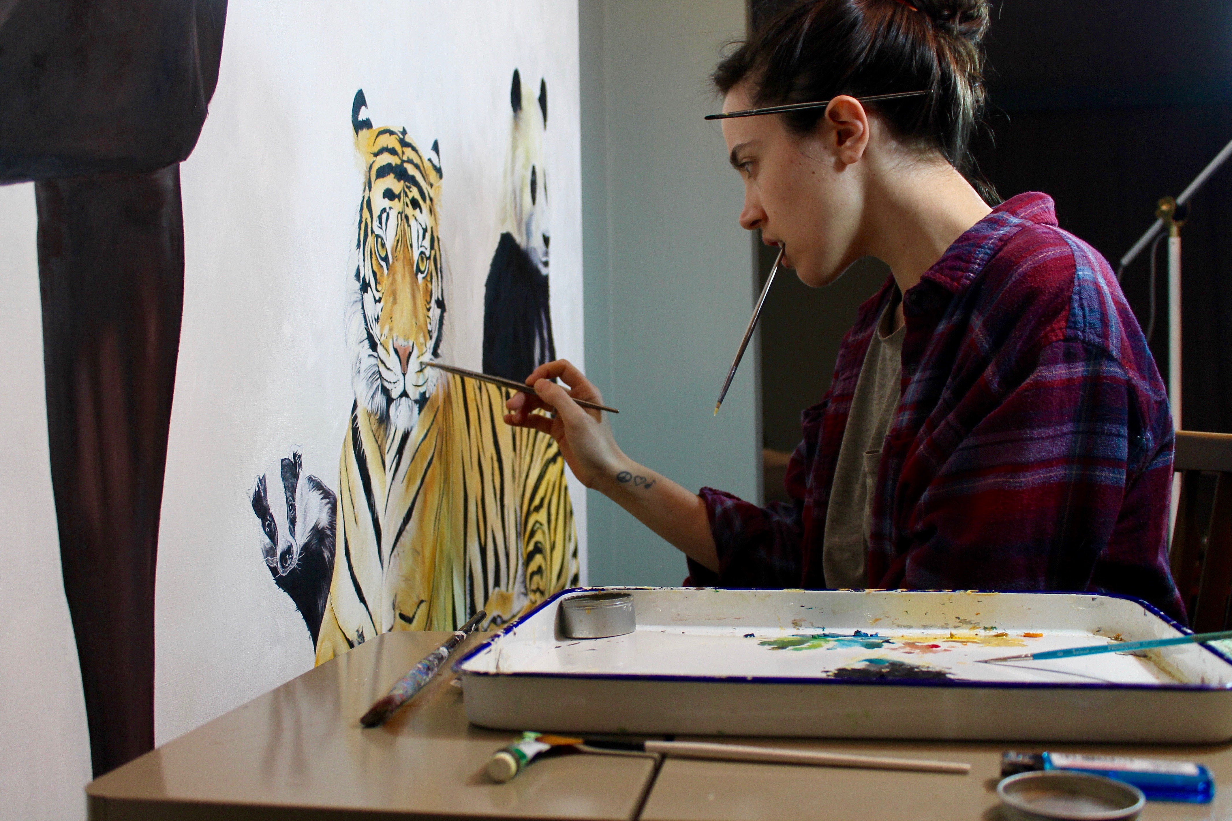 woman painting a tiger